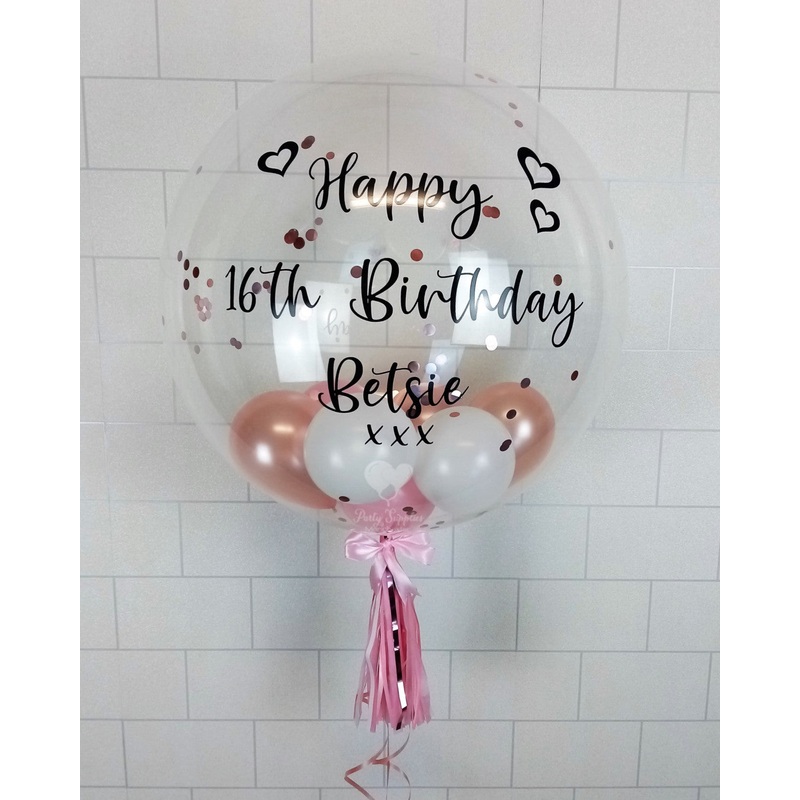 COLLECTION ONLY - Clear Bubble Balloon filled with Pink, Rose Gold & White Balloons finished with a Black Personalised Message & Dressed with a Tassel & Bow